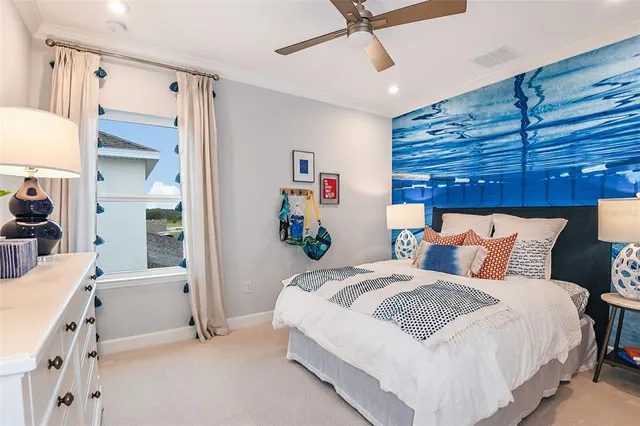 a bedroom with a bed and a lamp on dresser