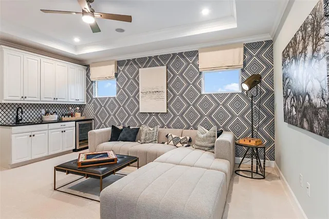 a living room with furniture ceiling fan and a rug