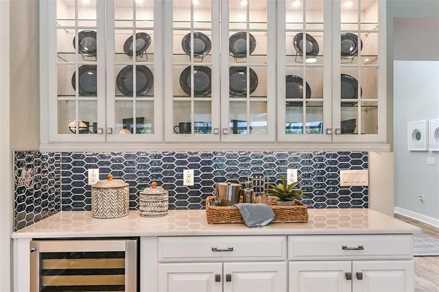 a large kitchen with kitchen island a flat screen tv a island and stainless steel appliances