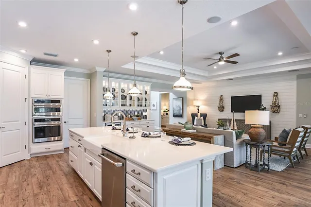 a large kitchen with kitchen island a sink and a stove