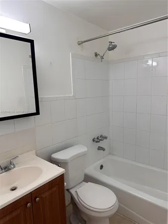 a bathroom with a glass door shower a sink and a bathtub
