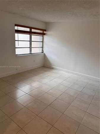 a bathroom with a shower and a glass door