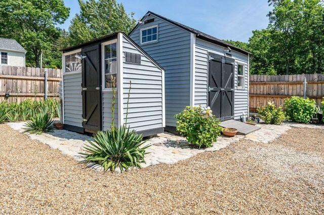 106 Old Great Neck Road Mashpee, MA 02649 - Photo 13 of 21 a view of a house with a yard and a garden