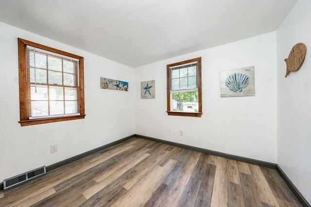 106 Old Great Neck Road Mashpee, MA 02649 - Photo 8 of 21 wooden floor in an empty room with a window