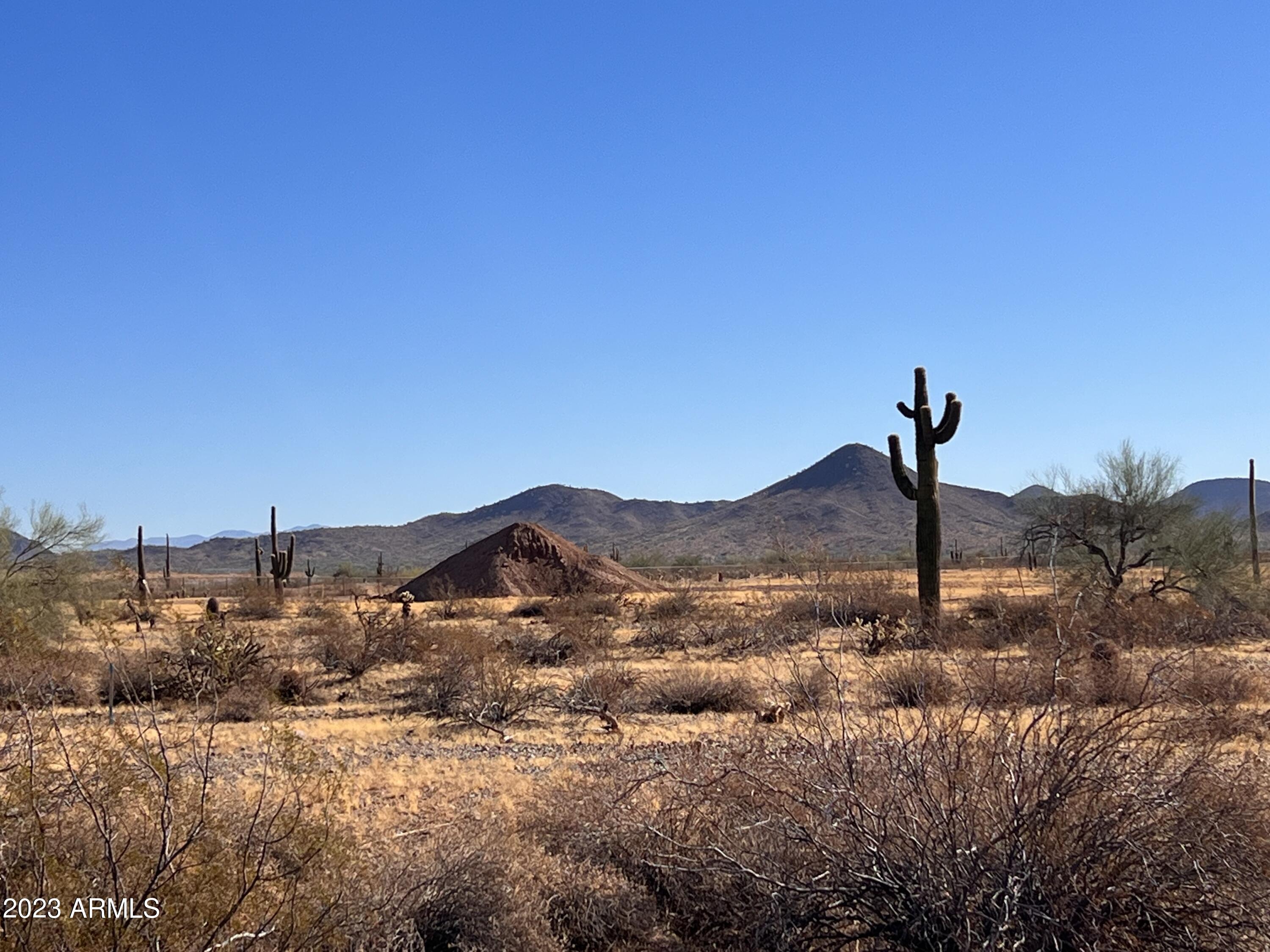 15648 West Montgomery Road, Unit 3 Surprise, AZ 85387 - Photo 4 of 8 a view of a house with a mountain and a forest