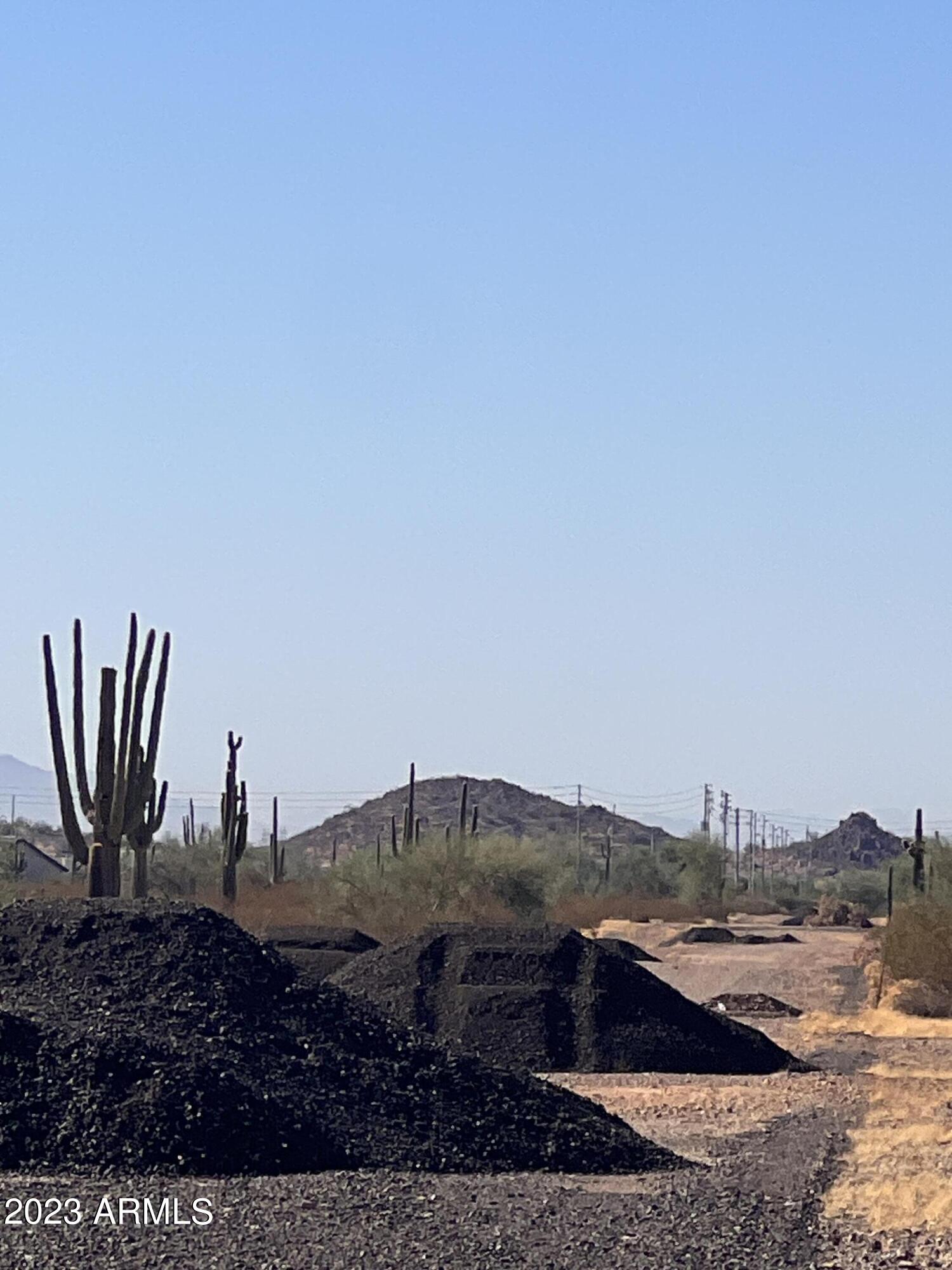 15648 West Montgomery Road, Unit 3 Surprise, AZ 85387 - Photo 6 of 8 a view of a dry yard with a house