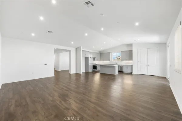 a view of an empty room with a kitchen