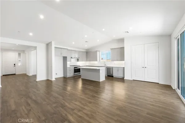 a view of a kitchen with furniture and wooden floor