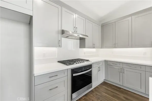 a kitchen with white cabinets and white appliances