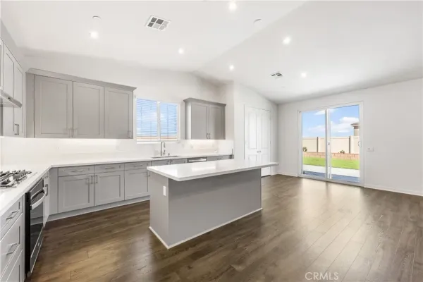 a kitchen with sink cabinets and wooden floor