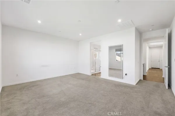 an empty room with closet and a window