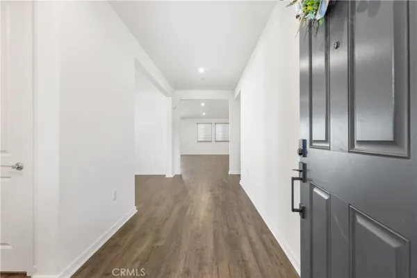 a view of a hallway with wooden floor