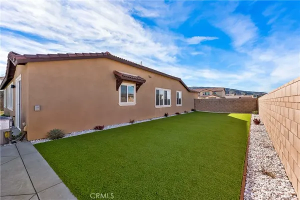 a view of a house with a yard and sitting area