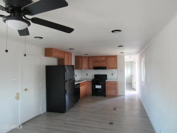 a kitchen with stainless steel appliances granite countertop a refrigerator and a stove