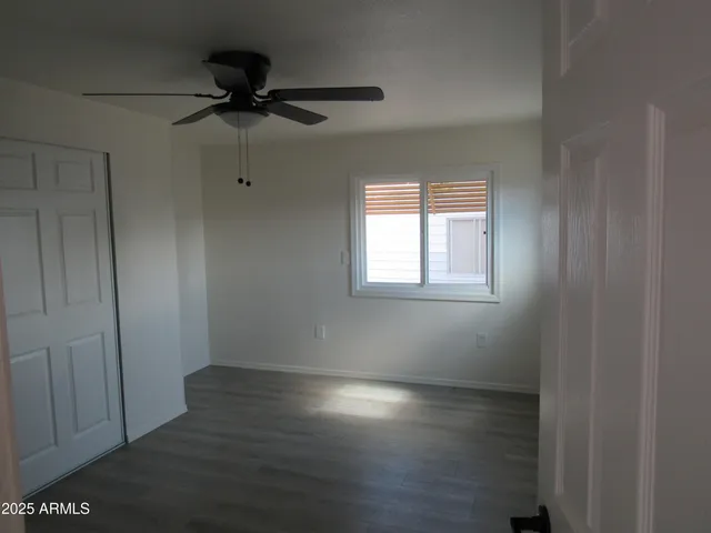 a view of a room with wooden floor