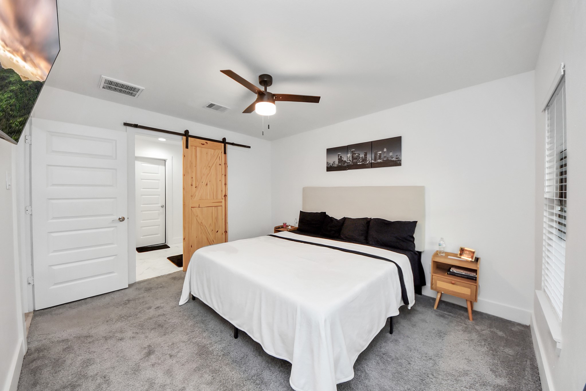 1110 Johnson Street Pasadena, TX 77506 - Photo 15 of 36 a bedroom with a bed and a ceiling fan