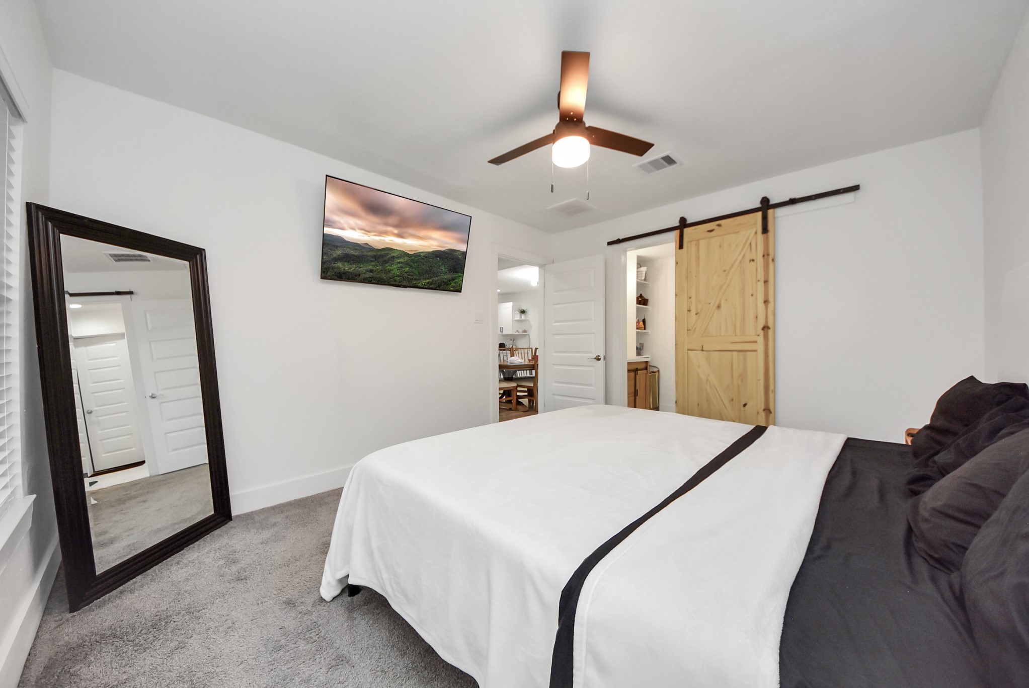 1110 Johnson Street Pasadena, TX 77506 - Photo 17 of 36 a spacious bedroom with a bed and a flat screen tv