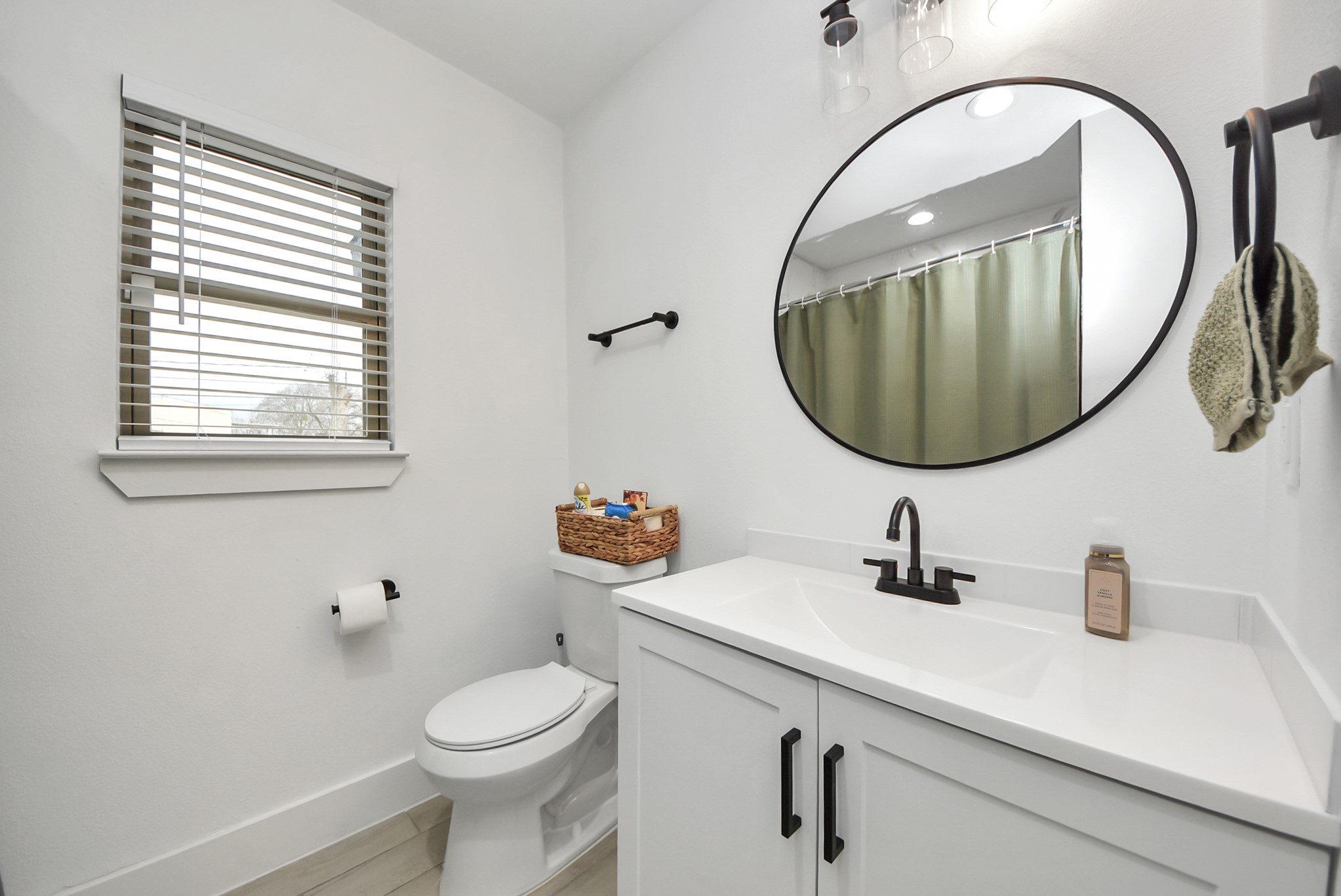 1110 Johnson Street Pasadena, TX 77506 - Photo 28 of 36 a bathroom with a sink a mirror a toilet and a window