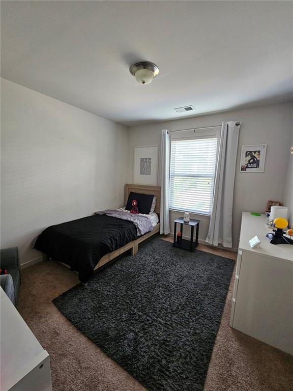 5747 Radford Loop Fairburn, GA 30213 - Photo 21 of 36 a bedroom with a bed and window