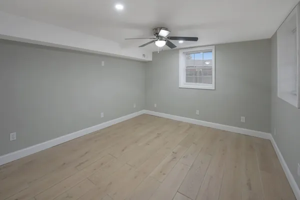a view of wooden floor and windows in a room