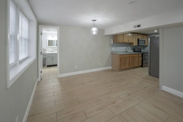 a kitchen with granite countertop a sink cabinets and stainless steel appliances