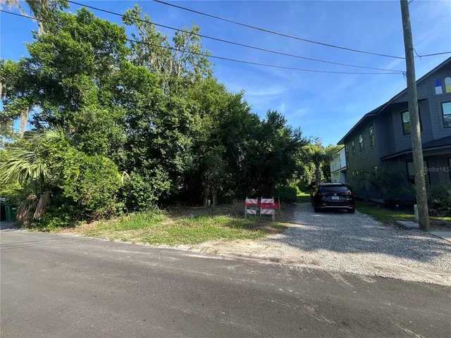 a view of backyard with table and chairs and potted plants