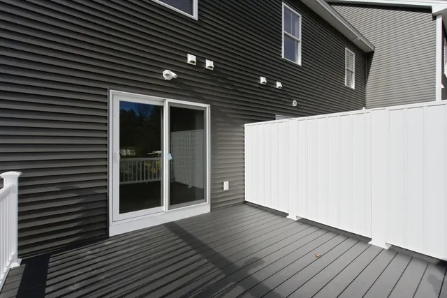 a balcony with wooden floor and fence