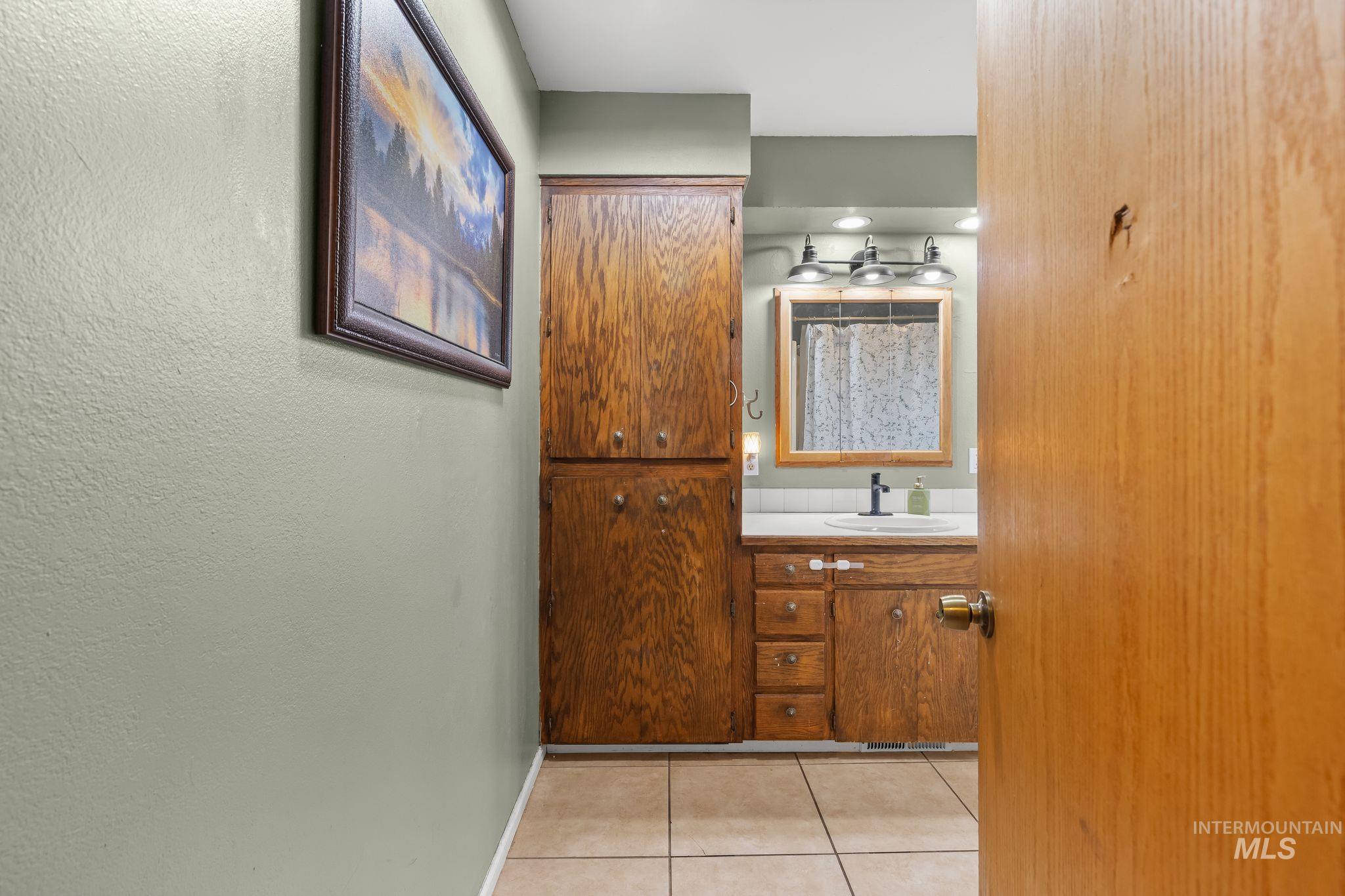 2119 Ripon Avenue Lewiston, ID 83501 - Photo 21 of 50 Bathroom featuring a wood-finish vanity with a white countertop and rectangular undermount sink