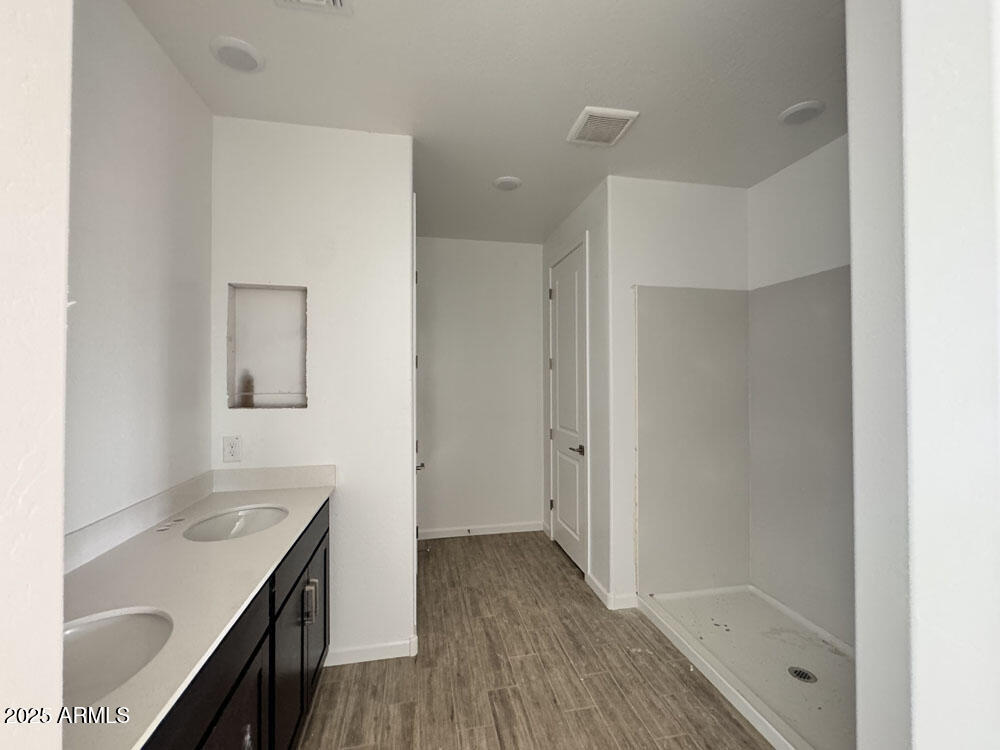 15793 West Beryl Avenue Waddell, AZ 85355 - Photo 12 of 34 a bathroom with a sink a mirror and a shower