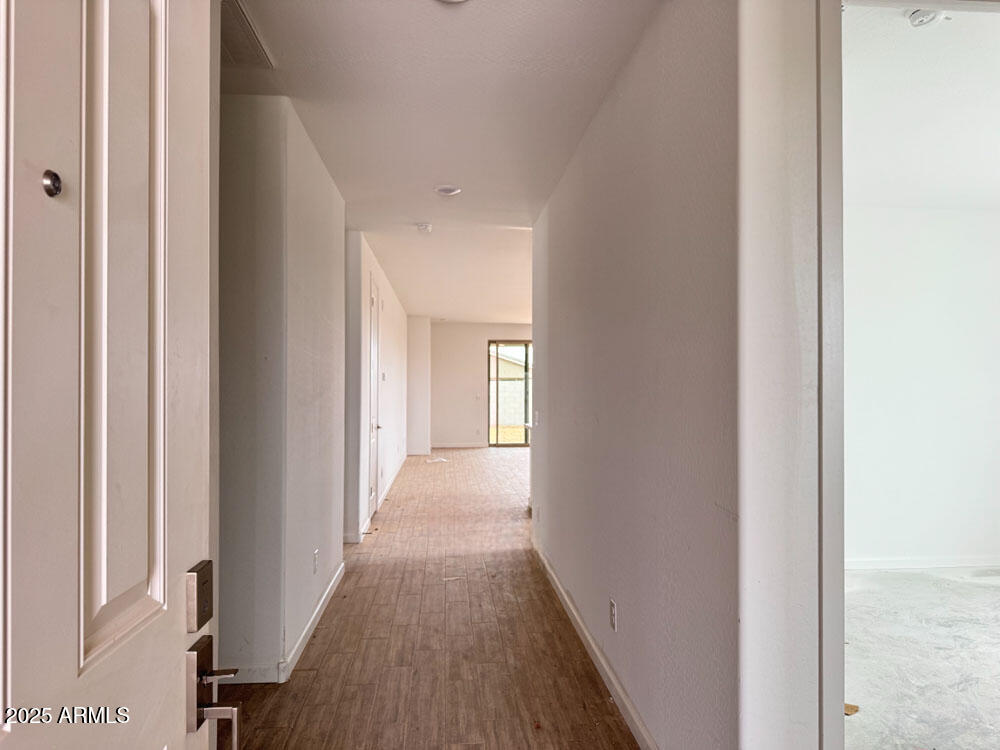 15793 West Beryl Avenue Waddell, AZ 85355 - Photo 3 of 34 a view of a hallway with wooden floor