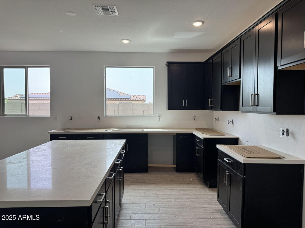 15793 West Beryl Avenue Waddell, AZ 85355 - Photo 7 of 34 a kitchen with a sink a stove and cabinets