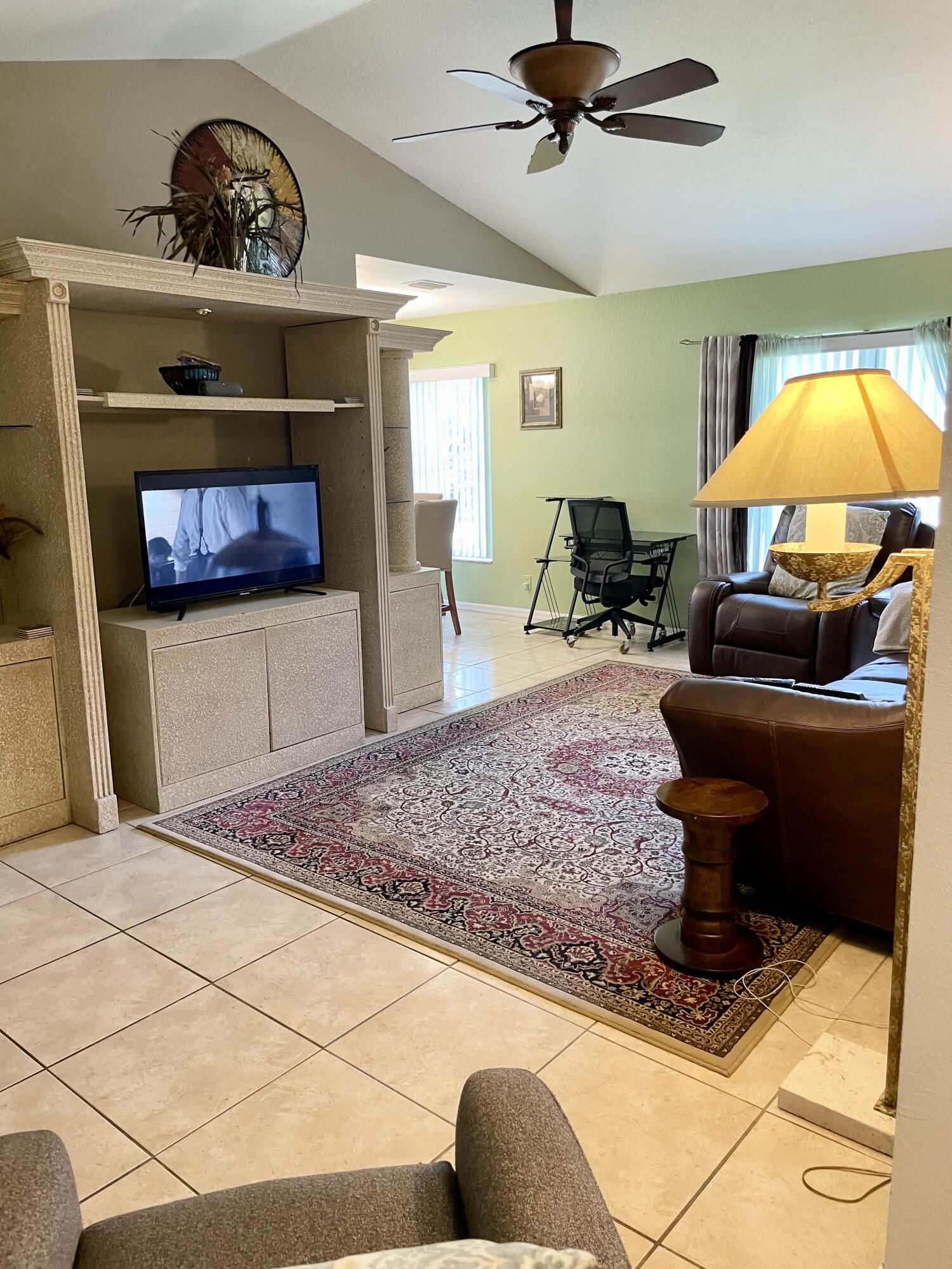 6644 4th Street Jupiter, FL 33458 - Photo 10 of 24 a living room with furniture and a fireplace