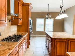 1306 Keenland Road Corpus Christi, TX 78418 - Photo 17 of 26 a kitchen with stainless steel appliances granite countertop a stove a sink and a refrigerator