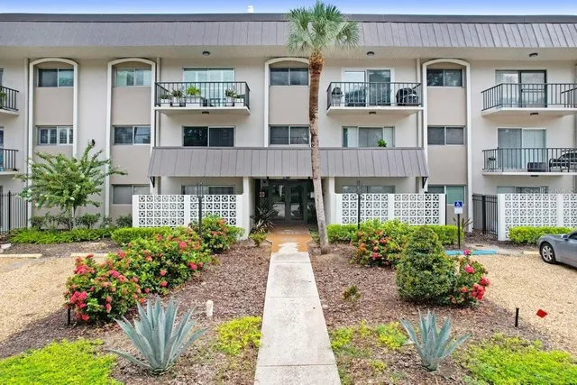 a front view of a building with garden