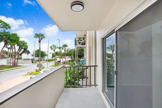 a view of a living room and a balcony