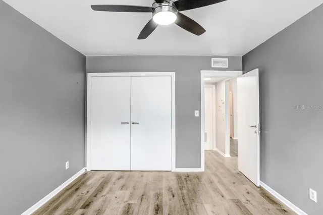 a view of empty room with wooden floor