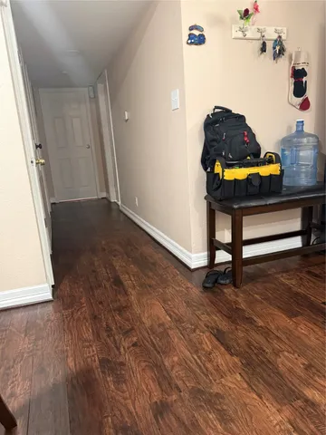 a room with wooden floor and furniture