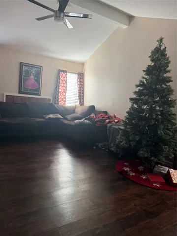 a living room with furniture and a floor to ceiling window