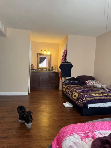 a bedroom with a bed and a dresser