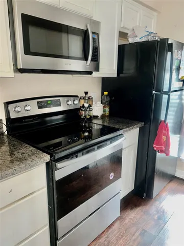 a kitchen with microwave and cabinets