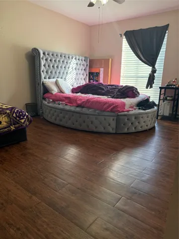 a bedroom with bed and window