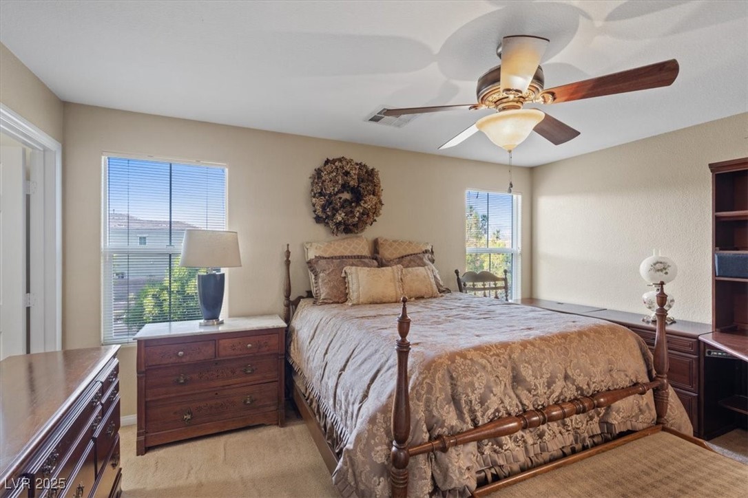 9116 Alpine Grove Avenue, Unit 103 Las Vegas, NV 89149 - Photo 14 of 30 Bedroom featuring light carpet and a ceiling fan