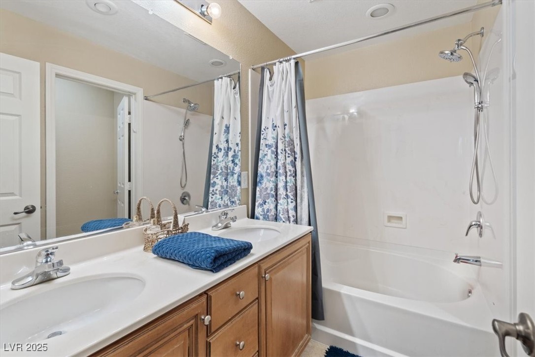 9116 Alpine Grove Avenue, Unit 103 Las Vegas, NV 89149 - Photo 18 of 30 Full bathroom featuring shower / bath combo and double vanity
