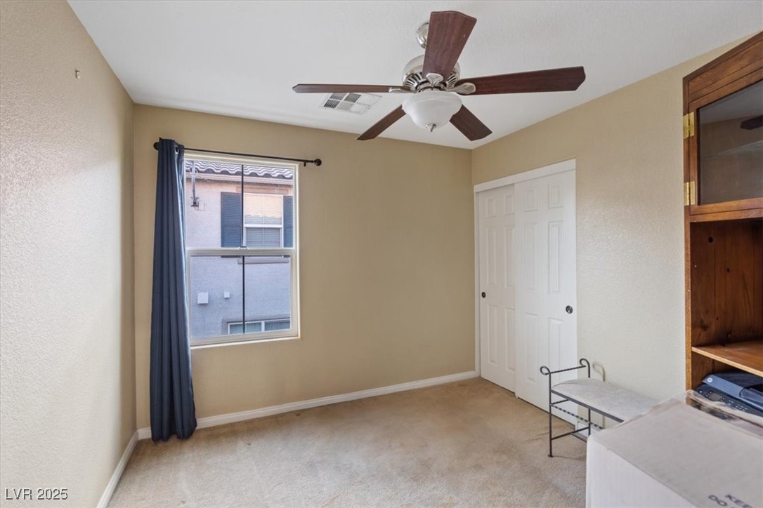 9116 Alpine Grove Avenue, Unit 103 Las Vegas, NV 89149 - Photo 19 of 30 Unfurnished office featuring light carpet, a ceiling fan, and a textured wall