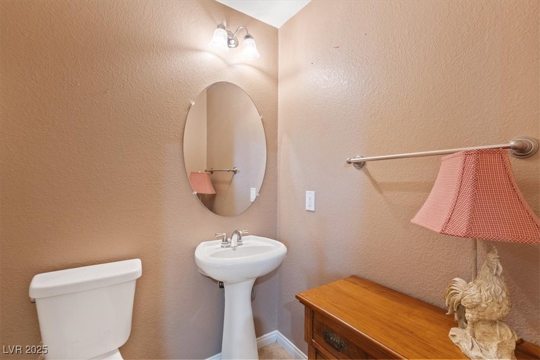 9116 Alpine Grove Avenue, Unit 103 Las Vegas, NV 89149 - Photo 20 of 30 Bathroom featuring a textured wall and toilet