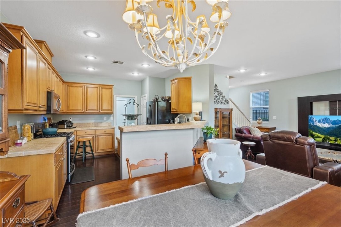 9116 Alpine Grove Avenue, Unit 103 Las Vegas, NV 89149 - Photo 8 of 30 Dining space featuring dark wood-style floors, recessed lighting, and stairway