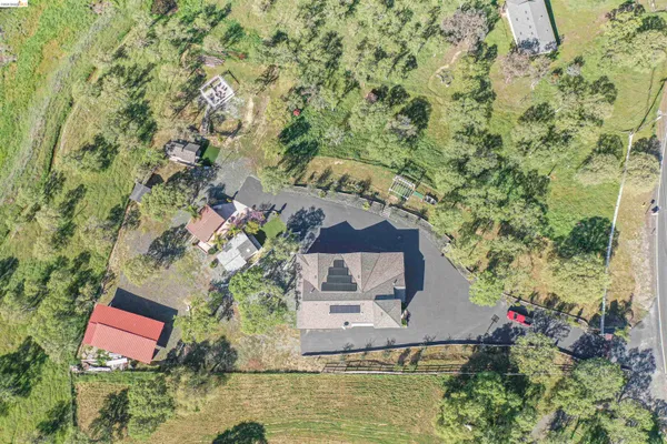an aerial view of a house with a yard