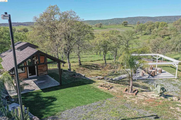 an aerial view of a house with a yard