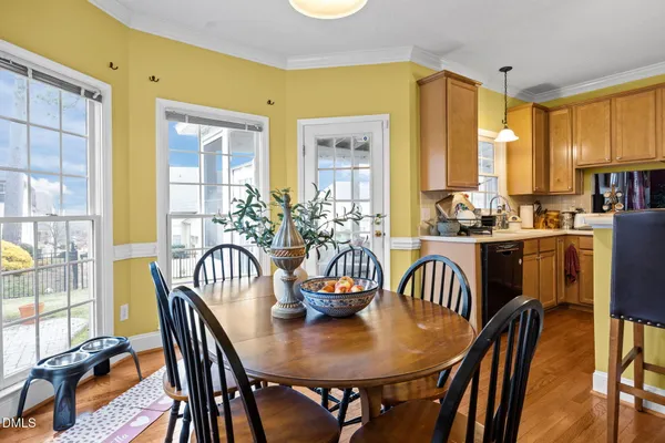 a view of a dining room with furniture and wooden floor