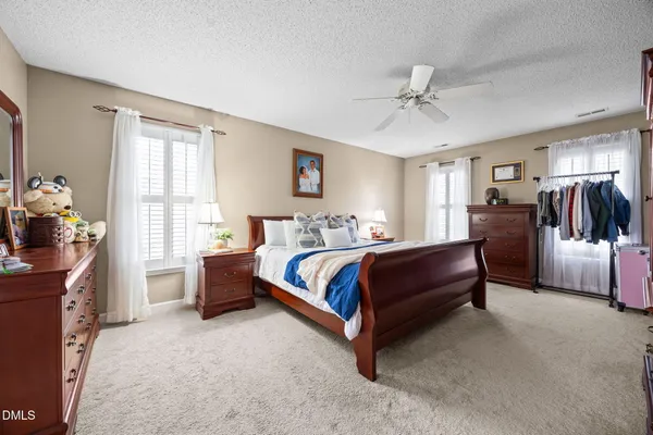 a spacious bedroom with a bed and window